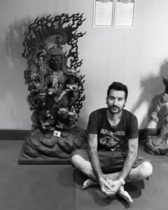 Beppe sitting beside a statue in Singapore, January 2010